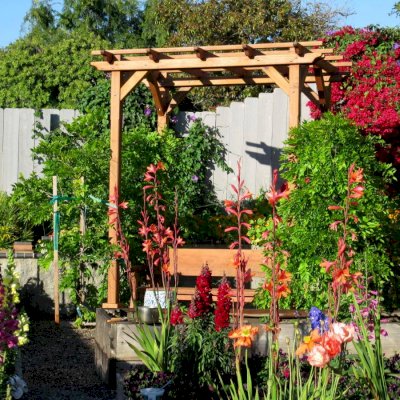 Small Garden Pergola Kit (Options: 8' L x 6' W, No Privacy Panels, California Redwood, 9 ft Post Height, 4-Post Anchor Kit for Stone, No Curtain Rods, No Decorative Trims, Transparent Premium Sealant).