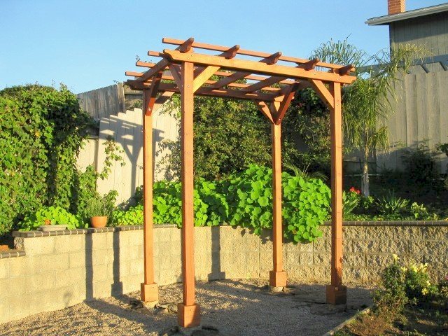 Small Pergola (Options: 8' x 8', Garden Type, Standard Timbers, Mature Redwood, Open Roof with Slats at 18", Rafters at 18", 9 ft Post Height, 4-Post Anchor Kit for Stone, No Ceiling Fan Base, No Privacy Panels, No Curtain Rods, Transparent Premium Sealant). Photo Courtesy of Aileen & Francis Knowles of San Diego, CA. Small Pergola (Options: 8' x 8', Garden Type, Standard Timbers, Mature Redwood, Open Roof with Slats at 18", Rafters at 18", 9 ft Post Height, 4-Post Anchor Kit for Stone, No Ceiling Fan Base, No Privacy Panels, No Curtain Rods, Transparent Premium Sealant). Photo Courtesy of Aileen & Francis Knowles of San Diego, CA.