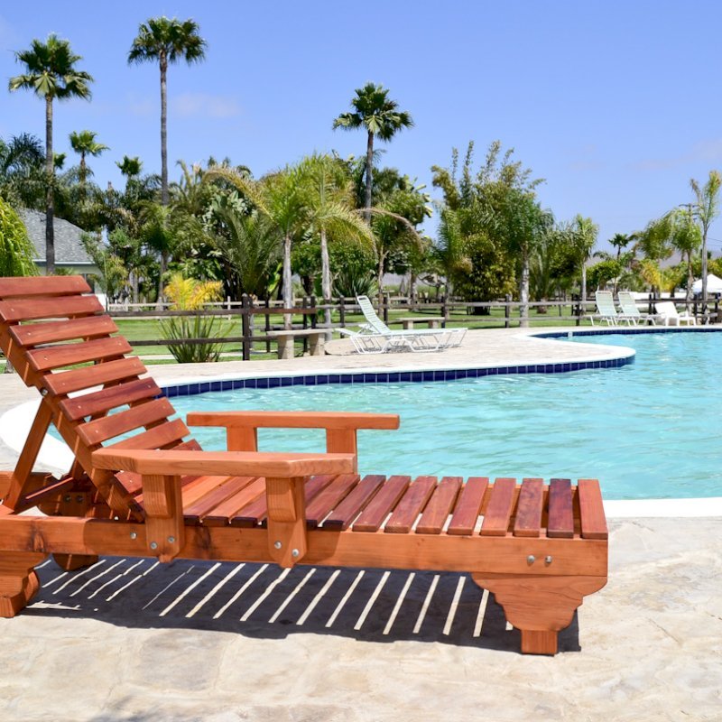 Sol Redwood Patio Lounger (Options: Single, Extra Large 78", Mature Redwood, Add Armrests, 13"H, Include Wooden Wheels, Transparent Premium Sealant). Photo also shows: The Poolside Privacy Panel Sol Redwood Patio Lounger (Options: Single, Extra Large 78", Mature Redwood, Add Armrests, 13"H, Include Wooden Wheels, Transparent Premium Sealant). Photo also shows: The Poolside Privacy Panel