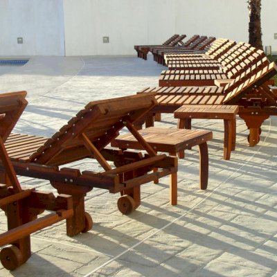 Sol Redwood Patio Lounger (Options: Single, Standard 74", Mature Redwood, 13" H, Wheels, No Cushion, Transparent Premium Sealant). Terrace Side tables shown between some of the Loungers.