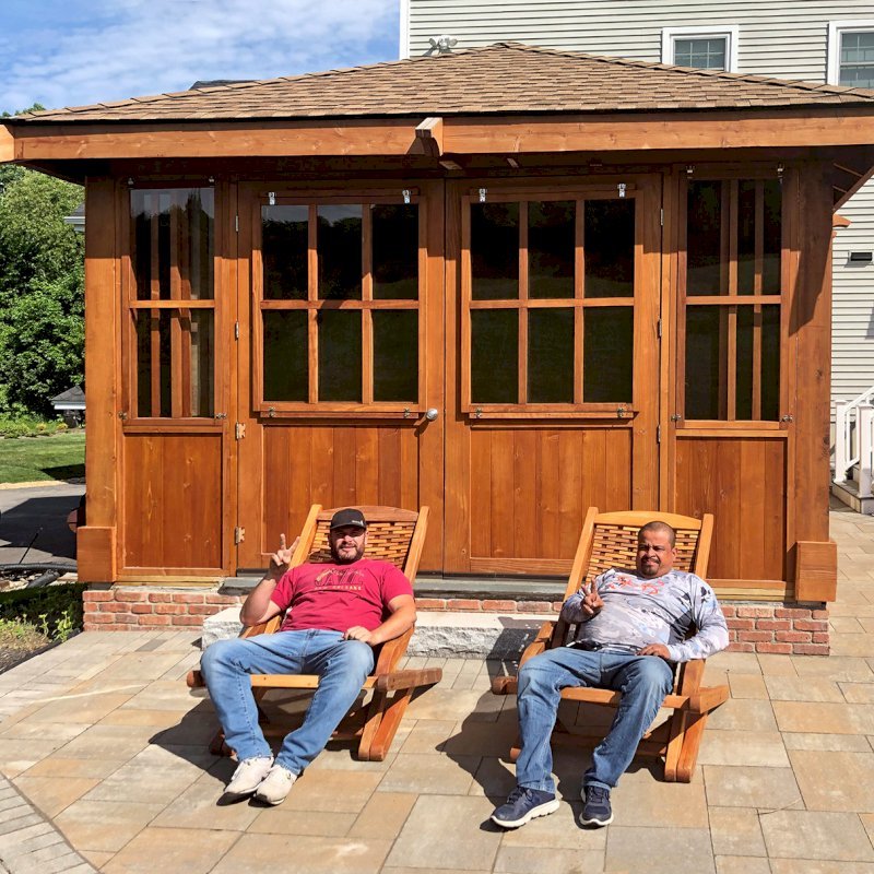 Spa Gazebo Kit (Options: 20' L, 14' W, Mature Redwood, All Sliding Windows, Without Skylight, Custom Roof, 36" H Siding Below Windows, Vertical Siding, Custom French Door without Screens, No Flooring, Transparent Premium Sealant). Photo Also Shows 2 Rio Hammock Chairs. Photo Courtesy of J. Zawalski of Groveland, Massachusetts. Spa Gazebo Kit (Options: 20' L, 14' W, Mature Redwood, All Sliding Windows, Without Skylight, Custom Roof, 36" H Siding Below Windows, Vertical Siding, Custom French Door without Screens, No Flooring, Transparent Premium Sealant). Photo Also Shows 2 Rio Hammock Chairs. Photo Courtesy of J. Zawalski of Groveland, Massachusetts.