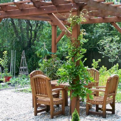 Square Patio Tables Under a Garden Pergola (Options: 4.5', 4 Chairs, Mature Redwood, Luna Style Chairs, Armchairs Only, No Cushions, Standard tabletop option, Slightly Rounded corners, No Umbrella Hole, Transparent Premium Sealant).  