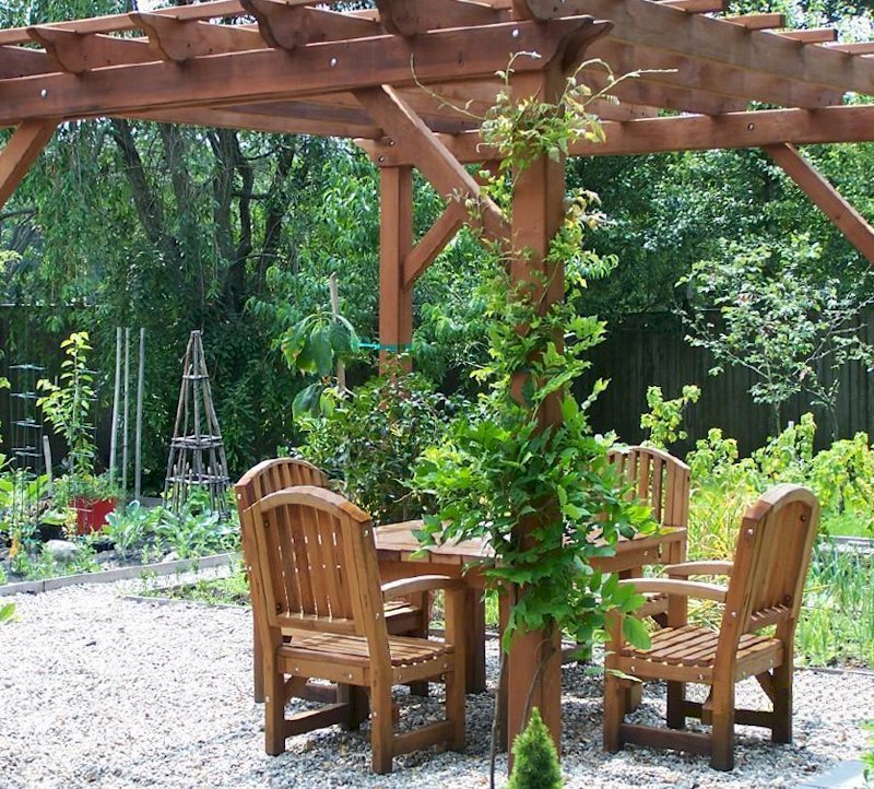 Square Patio Table Under a Garden Pergola (Options: 4.5', 4 Chairs, Mature Redwood, Luna Style Chairs, Armchairs Only, No Cushions, Standard tabletop option, Slightly Rounded corners, No Umbrella Hole, Transparent Premium Sealant). Square Patio Table Under a Garden Pergola (Options: 4.5', 4 Chairs, Mature Redwood, Luna Style Chairs, Armchairs Only, No Cushions, Standard tabletop option, Slightly Rounded corners, No Umbrella Hole, Transparent Premium Sealant).