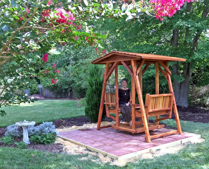 St. Anthony's Face to Face Gliders (Adult Size, Redwood, No Beverage Armrests, No Kid's Platform, Standard Closed Roof, No Engraving, Transparent Premium Sealant). Photo Courtesy of Dulce B. of Yorktown, VA. St. Anthony's Face to Face Gliders (Adult Size, Redwood, No Beverage Armrests, No Kid's Platform, Standard Closed Roof, No Engraving, Transparent Premium Sealant). Photo Courtesy of Dulce B. of Yorktown, VA.