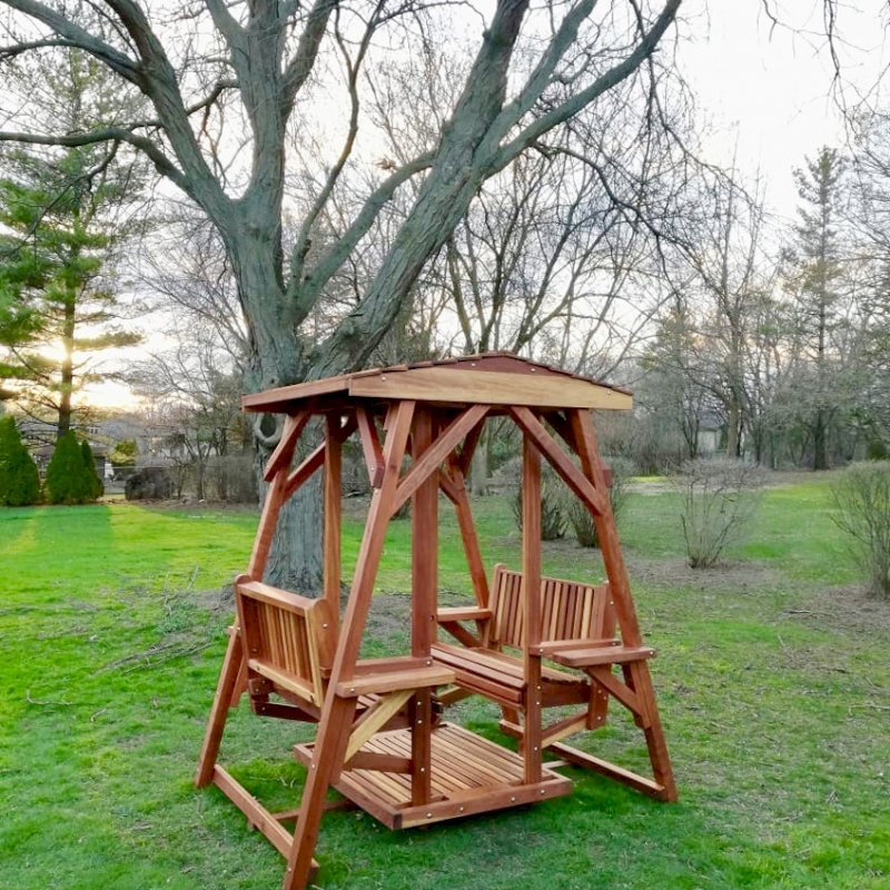 St. Anthony's Face to Face Gliders (Adult Size, Redwood, With Beverage Armrests, No Kid's Platform, Standard Closed Roof, No Engraving, Transparent Premium Sealant). Photo Courtesy of N. Prokuski of Burr Ridge, Illinois. St. Anthony's Face to Face Gliders (Adult Size, Redwood, With Beverage Armrests, No Kid's Platform, Standard Closed Roof, No Engraving, Transparent Premium Sealant). Photo Courtesy of N. Prokuski of Burr Ridge, Illinois.