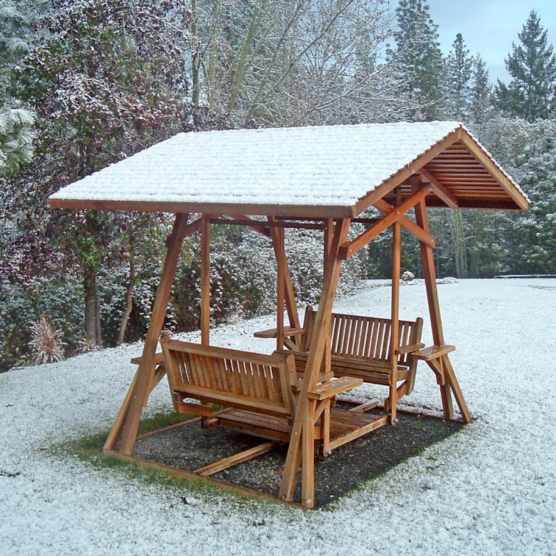 St. Anthony's Face to Face Gliders (Adult Size, Redwood, With Beverage Armrests, No Kid's Platform, XW Roof, No Engraving, Transparent Premium Sealant). Photo Courtesy of Rosalie Hurd of Grants Pass, Oregon. St. Anthony's Face to Face Gliders (Adult Size, Redwood, With Beverage Armrests, No Kid's Platform, XW Roof, No Engraving, Transparent Premium Sealant). Photo Courtesy of Rosalie Hurd of Grants Pass, Oregon.