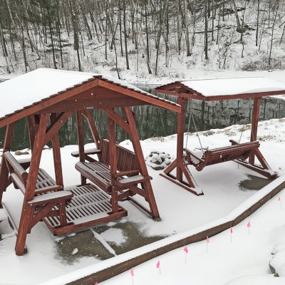 St. Anthony's Face to Face Gliders (XW, California Redwood, With Beverage Armrests, No Kid's Platform, XW Roof, No Engraving, Cherry Stain Premium Sealant). Photo also shows a Bench Swing Set. Photo Courtesy of T. Marling of Mount Horeb, WI.