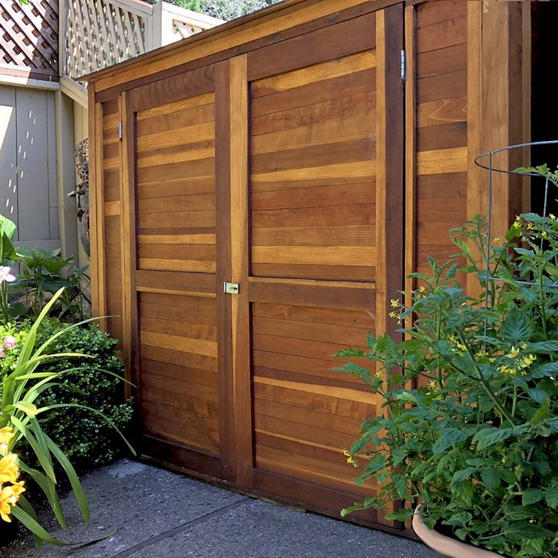 Storage Shed (Options: 7' W, 4.5' D, 7' H, Redwood, Double Doors, No Shelving, With Deck, Transparent Premium Sealant). Photo Courtesy of I. Speiser of Carmel, CA Storage Shed (Options: 7' W, 4.5' D, 7' H, Redwood, Double Doors, No Shelving, With Deck, Transparent Premium Sealant). Photo Courtesy of I. Speiser of Carmel, CA