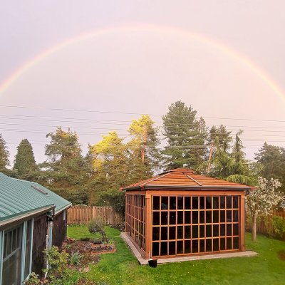 Still Warm and Inviting Even in the Rain. Sun Gazebo with Sliding Doors (Options: 20' L x 16' W, Exterior Skin and Roofing in California Redwood, Rest of Structure Will Be in Douglas-Fir, 8 ft Wall Height, With 4' x 8' Skylight, No Flooring, Standard Wood Roof, Transparent Premium Sealant). Photo Courtesy of R. Huffman of Seattle, WA.