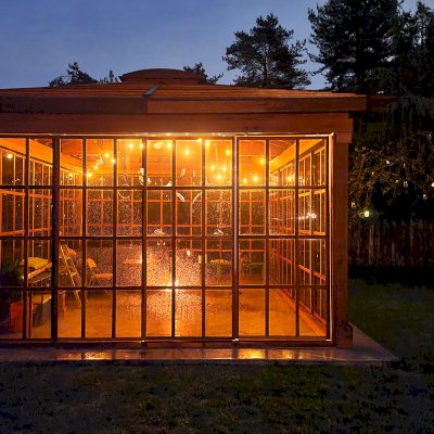 Still Warm and Inviting Even in the Rain. Sun Gazebo with Sliding Doors (Options: 20' L x 16' W, Exterior Skin and Roofing in California Redwood, Rest of Structure Will Be in Douglas-Fir, 8 ft Wall Height, With 4' x 8' Skylight, No Flooring, Standard Wood Roof, Transparent Premium Sealant). Photo Courtesy of R. Huffman of Seattle, WA.
