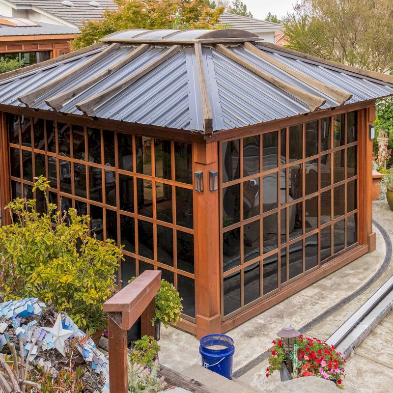 Sun Gazebo with Sliding Doors (Options: 14' L, 12' W, California Redwood, 4' x 6' Skylight, Complete Floor, Transparent Premium Sealant). Metal roof added by custom request. The roof timbers were not resealed and are 4 years old while the rest of the structure was resealed recently. Photo Courtesy of A. Ramon of South San Francisco, CA. Note: Metal Roof provided by Home Depot: 12ft. Classic Rib Steel Roof Panel in Charcoal, Model #2313417, Internet #204255071 Sun Gazebo with Sliding Doors (Options: 14' L, 12' W, California Redwood, 4' x 6' Skylight, Complete Floor, Transparent Premium Sealant). Metal roof added by custom request. The roof timbers were not resealed and are 4 years old while the rest of the structure was resealed recently. Photo Courtesy of A. Ramon of South San Francisco, CA. Note: Metal Roof provided by Home Depot: 12ft. Classic Rib Steel Roof Panel in Charcoal, Model #2313417, Internet #204255071
