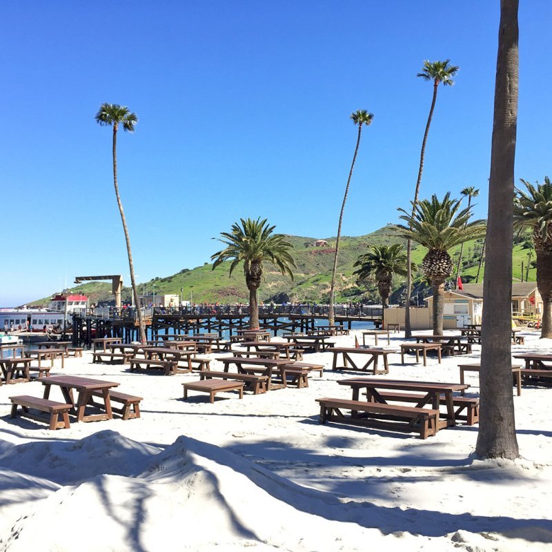 The Classic Redwood Patio Table (Options: California Redwood, Side Benches, 1 Full Length Bench Per Side, Standard Tabletop, Slightly Rounded Corners, No Umbrella Hole, Coffee Stain Premium Sealant). Photo Shows Customized Version of Patio Tables. Tables Installed in Catalina Island, CA. The Classic Redwood Patio Table (Options: California Redwood, Side Benches, 1 Full Length Bench Per Side, Standard Tabletop, Slightly Rounded Corners, No Umbrella Hole, Coffee Stain Premium Sealant). Photo Shows Customized Version of Patio Tables. Tables Installed in Catalina Island, CA.