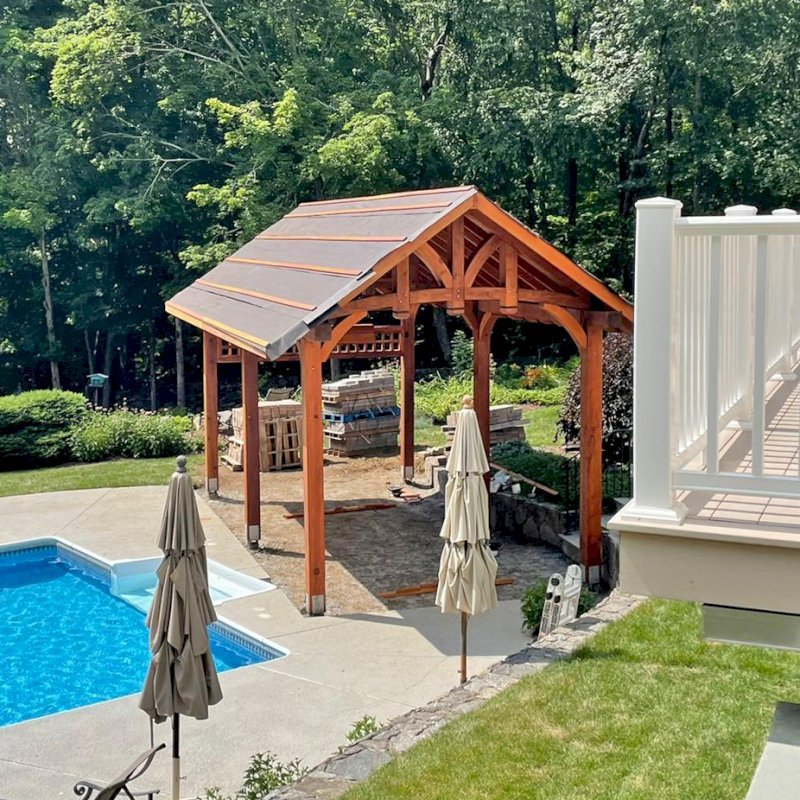 Custom The Granada Pavilion (Options: 25 ft x 15 ft, California Redwood, 6-Post Anchor Kit for High-Wind, Custom Lattice Frame to Mount TV, with Fascia Board, with 2 Curtain Rods, 1 Ceiling Fan Base, Transparent Premium Sealant). Pavilion Under Construction While This Photo was Taken. Photo Courtesy of C. Soto of Monroe, Connecticut. Custom The Granada Pavilion (Options: 25 ft x 15 ft, California Redwood, 6-Post Anchor Kit for High-Wind, Custom Lattice Frame to Mount TV, with Fascia Board, with 2 Curtain Rods, 1 Ceiling Fan Base, Transparent Premium Sealant). Pavilion Under Construction While This Photo was Taken. Photo Courtesy of C. Soto of Monroe, Connecticut.