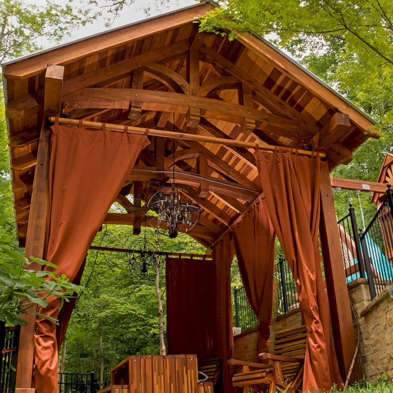 The Granada Pavilion (Options: 18' L x 15' W, California Redwood with a 15-year warranty, 4-post Anchor Kit for Gale-Wind, Electrical Wiring Trim for 1 Post, 3 Ceiling Fan Bases, 4 Curtain Rods, Transparent Premium Sealant). Photo Courtesy of J. Rynerson of Franklin, Tennessee. The Granada Pavilion (Options: 18' L x 15' W, California Redwood with a 15-year warranty, 4-post Anchor Kit for Gale-Wind, Electrical Wiring Trim for 1 Post, 3 Ceiling Fan Bases, 4 Curtain Rods, Transparent Premium Sealant). Photo Courtesy of J. Rynerson of Franklin, Tennessee.