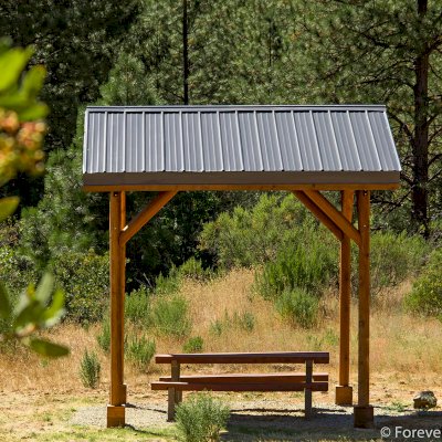 Humboldt Log Pavilion (Options: 6in x 6in Posts Thickness, 12ft L x 12ft W, No Privacy Panels, California Redwood, 2 Fascia Boards for Gutters, 9.5ft Post Height, No Electrical Wiring Trim, 4-Post Anchor Kit for High-Wind, No Ceiling Fan Fan Bases, No Curtain Rods, Transparent Premium Sealant). Metal Roof Installed by Custom Request.