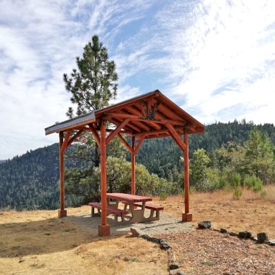 Humboldt Log Pavilion (Options: 6in x 6in Posts Thickness, 12ft L x 12ft W, No Privacy Panels, California Redwood, 2 Fascia Boards for Gutters, 9.5ft Post Height, No Electrical Wiring Trim, 4-Post Anchor Kit for High-Wind, No Ceiling Fan Fan Bases, No Curtain Rods, Transparent Premium Sealant). Metal Roof Installed by Custom Request.