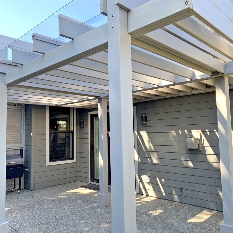 Custom L.A. Modern Pergola (Options: 17' L, 12' W, Douglas-fir, 10.5 ft Post Height, No Electrical Wiring Trim Kit, 4 Post Anchor Kit for Concrete, No Ceiling Fan Base, with Transparent Rain Guard, Custom Paint Finish) with 1 Standalone Privacy Panel (Louvered). Photo Courtesy of J. Williamson of Bow, Washington. Custom L.A. Modern Pergola (Options: 17' L, 12' W, Douglas-fir, 10.5 ft Post Height, No Electrical Wiring Trim Kit, 4 Post Anchor Kit for Concrete, No Ceiling Fan Base, with Transparent Rain Guard, Custom Paint Finish) with 1 Standalone Privacy Panel (Louvered). Photo Courtesy of J. Williamson of Bow, Washington.