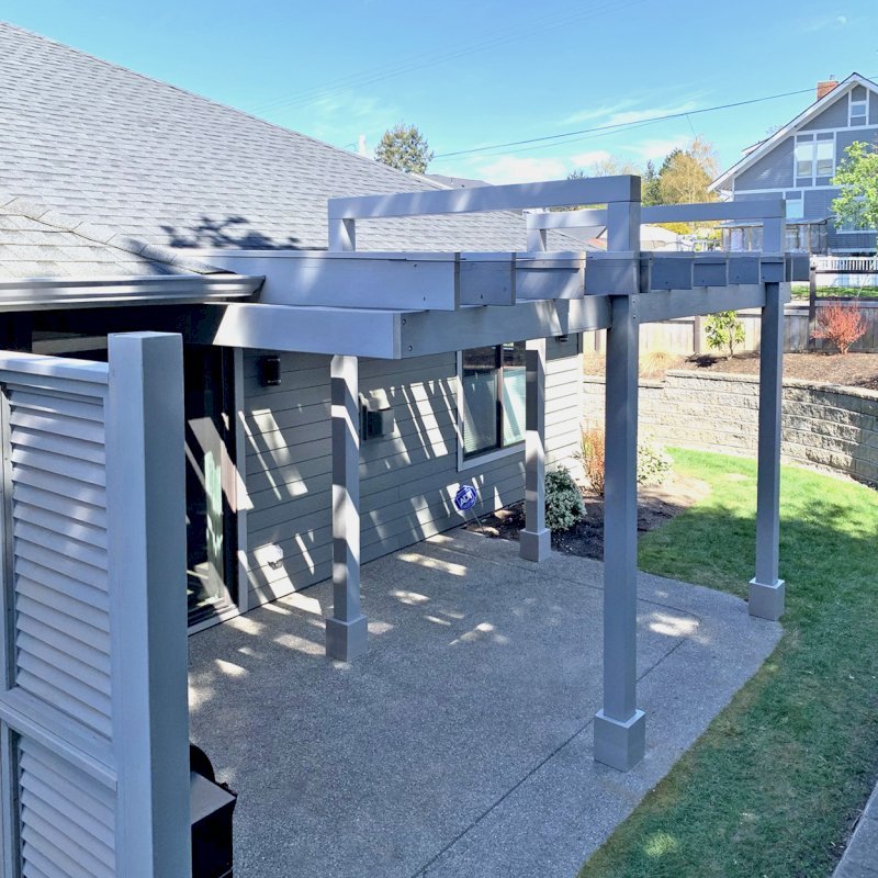 Custom L.A. Modern Pergola (Options: 17' L, 12' W, Douglas-fir, 10.5 ft Post Height, No Electrical Wiring Trim Kit, 4 Post Anchor Kit for Concrete, No Ceiling Fan Base, with Transparent Rain Guard, Custom Paint Finish) with 1 Standalone Privacy Panel (Louvered). Photo Courtesy of J. Williamson of Bow, Washington. Custom L.A. Modern Pergola (Options: 17' L, 12' W, Douglas-fir, 10.5 ft Post Height, No Electrical Wiring Trim Kit, 4 Post Anchor Kit for Concrete, No Ceiling Fan Base, with Transparent Rain Guard, Custom Paint Finish) with 1 Standalone Privacy Panel (Louvered). Photo Courtesy of J. Williamson of Bow, Washington.