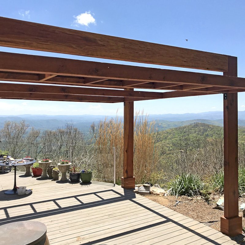 Custom L.A. Modern Pergola (options: 16' L, 13' W, California Redwood, No Rain Guard, 12" x 4" Posts & Supports, 10 ft Post Height, No Electrical Wiring Trim, 4 Post Anchor Kit for Gale-Wind, No Ceiling Fan Base, Retractable Shade Canopy will be Installed, Transparent Premium Sealant). Photo Courtesy of W. Craig of Fairview, North Carolina. Blue Ridge Mountains in the background. Custom L.A. Modern Pergola (options: 16' L, 13' W, California Redwood, No Rain Guard, 12" x 4" Posts & Supports, 10 ft Post Height, No Electrical Wiring Trim, 4 Post Anchor Kit for Gale-Wind, No Ceiling Fan Base, Retractable Shade Canopy will be Installed, Transparent Premium Sealant). Photo Courtesy of W. Craig of Fairview, North Carolina. Blue Ridge Mountains in the background.