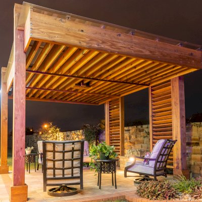 The L.A. Modern Pergola (options: 16' L, 12' W, California Redwood, with Rain Guard, 10 ft Post Height, 2 Electrical Wiring Trims, 4-Post Anchor Kit for Concrete, 1 Ceiling Fan Base, No Retractable Shade Canopy, Transparent Premium Sealant). Photo Taken 1 Year After Installation. Photo Courtesy of T. Huber of Round Rock, TX.