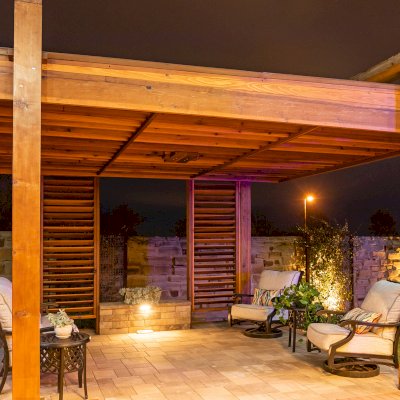 The L.A. Modern Pergola (options: 16' L, 12' W, California Redwood, with Rain Guard, 10 ft Post Height, 2 Electrical Wiring Trims, 4-Post Anchor Kit for Concrete, 1 Ceiling Fan Base, No Retractable Shade Canopy, Transparent Premium Sealant). Photo Taken 1 Year After Installation. Photo Courtesy of T. Huber of Round Rock, TX.