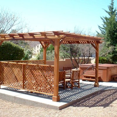 Lattice Pergola Kit (Options: 15' x 15', California Redwood, No Electrical Wiring Trim, 4-post Anchor Kit for Concrete, No Ceiling Fan Base, 2 Privacy Panels, No Curtain Rods, 9' Post Height, Transparent Premium Sealant). 2x2 Slats Above Rafters was Added as Custom Detail. It is not Part of Standard Design. Under the Pergola, a 7' San Francisco Patio Table Set with 42" W Tabletop, 4 Ruth Chairs and 2 Ruth Armchairs. Photo Courtesy of Mr. Joseph Dlugosz of Sedona, AZ.