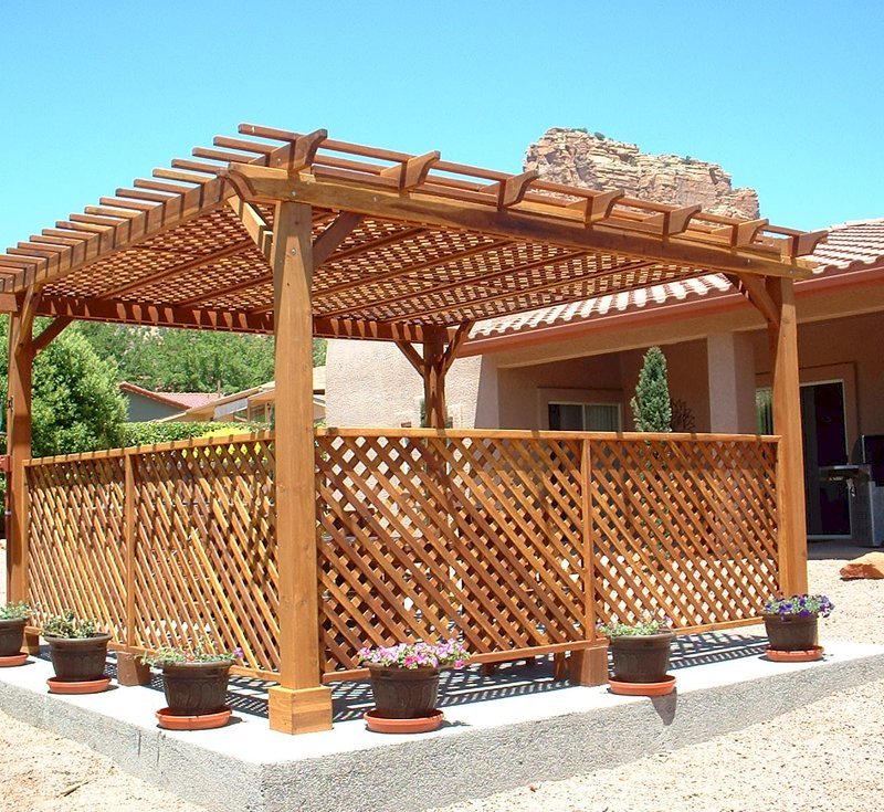 The Lattice Pergola Kit (Options: 15' x 15', California Redwood, No Electrical Wiring Trim, Lattice Panel Roof, 4-post Anchor Kit for Stone, No Ceiling Fan Base, 2 Privacy Panels, No Curtain Rods, 9' Post Height, Transparent Premium Sealant). Under the Pergola, a 7' San Francisco Patio Table Set with 42" W Tabletop, 4 Ruth Chairs and 2 Ruth Armchairs. Photo Courtesy of Mr. Joseph Dlugosz of Sedona, AZ. The Lattice Pergola Kit (Options: 15' x 15', California Redwood, No Electrical Wiring Trim, Lattice Panel Roof, 4-post Anchor Kit for Stone, No Ceiling Fan Base, 2 Privacy Panels, No Curtain Rods, 9' Post Height, Transparent Premium Sealant). Under the Pergola, a 7' San Francisco Patio Table Set with 42" W Tabletop, 4 Ruth Chairs and 2 Ruth Armchairs. Photo Courtesy of Mr. Joseph Dlugosz of Sedona, AZ.