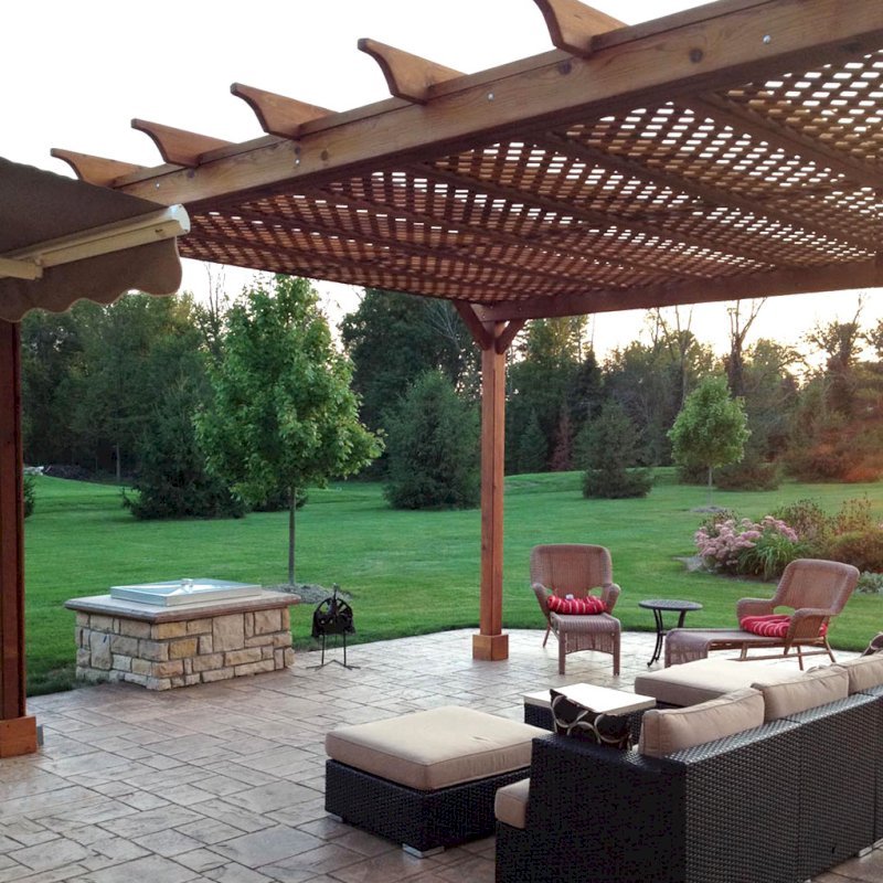 The Lattice Pergola Kit (Options: 20' L x 16' W, Mature Redwood, No Electrical Wiring Trim, Lattice Roof, Lengthwise Roof Support Timbers, 4-Post Kit for Stone, Brick, or Concrete, No Ceiling Fan Base, No Privacy Panels, No Curtain Rods, 10' Post Height, Transparent Premium Sealant). Photo Courtesy of David Wilson. The Lattice Pergola Kit (Options: 20' L x 16' W, Mature Redwood, No Electrical Wiring Trim, Lattice Roof, Lengthwise Roof Support Timbers, 4-Post Kit for Stone, Brick, or Concrete, No Ceiling Fan Base, No Privacy Panels, No Curtain Rods, 10' Post Height, Transparent Premium Sealant). Photo Courtesy of David Wilson.