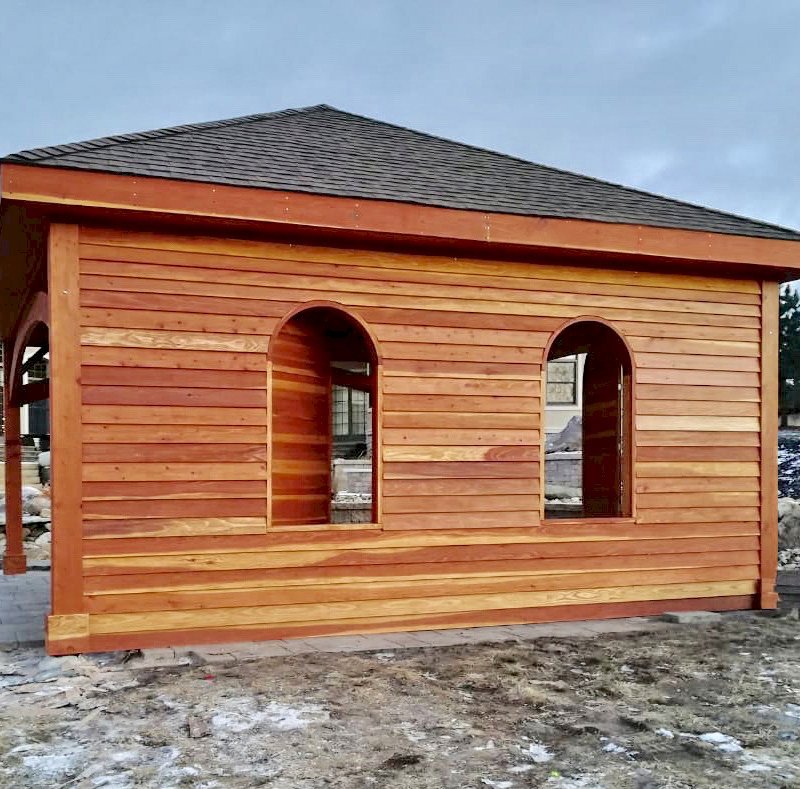 The Loreto Pavilion (Options: 20' L x 20' W, No Privacy Panels, California Redwood, 10' H, Electrical Wiring Trim for 1 Post, 4-Post Anchor Kit for Gale-Wind, No Post Decorative Trim, 1 Ceiling Fan Base, No Curtain Rods, Transparent Premium Sealant, Custom Wall with Shutters). Photo Courtesy of A. Schurman of Cedar Falls, Iowa. The Loreto Pavilion (Options: 20' L x 20' W, No Privacy Panels, California Redwood, 10' H, Electrical Wiring Trim for 1 Post, 4-Post Anchor Kit for Gale-Wind, No Post Decorative Trim, 1 Ceiling Fan Base, No Curtain Rods, Transparent Premium Sealant, Custom Wall with Shutters). Photo Courtesy of A. Schurman of Cedar Falls, Iowa.