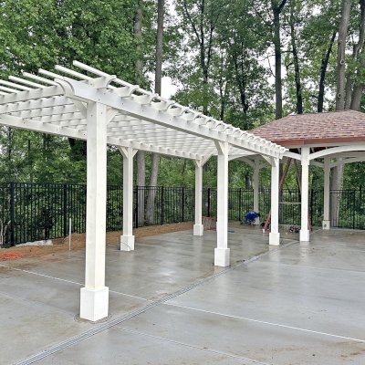 Loreto Pavilion (Options: 24' L x 16' W, 8x8 Posts, No Privacy Panels, Douglas-Fir, 11.9' H Posts, 4 Electrical Wiring Trims, 6-Post Anchor Kit for Concrete, No Post Decorative Trims, 2 Ceiling Fan Bases, No Curtain Rods, White Stain Premium Sealant). Photo Also Shows a Traditional Garden Pergola. Photo Courtesy of Wildwood Manor Pool in Bethseda, MD