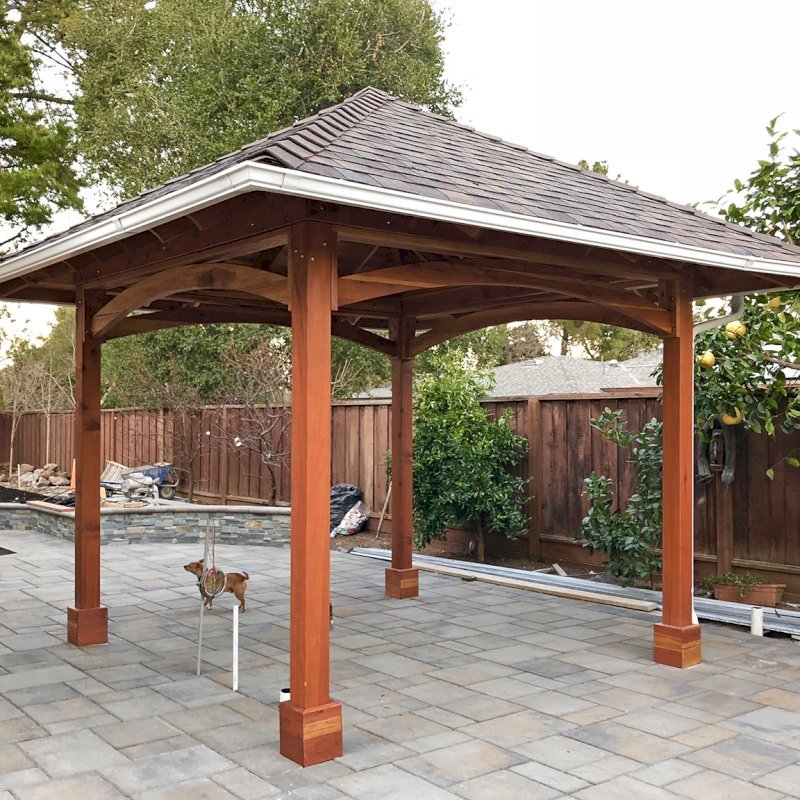 The Loreto Pavilion (Options: 14' x 14', California Redwood, Post Anchor Kit for Gale-Wind, 1 Electrical Wiring Trim Kit, 2ft Overhangs by Custom Request, Transparent Premium Sealant). Gutters added by Forever Redwood install team and can be added to any pavilion by request. Photo Courtesy of B. Hirschbeck of Los Altos, CA. The Loreto Pavilion (Options: 14' x 14', California Redwood, Post Anchor Kit for Gale-Wind, 1 Electrical Wiring Trim Kit, 2ft Overhangs by Custom Request, Transparent Premium Sealant). Gutters added by Forever Redwood install team and can be added to any pavilion by request. Photo Courtesy of B. Hirschbeck of Los Altos, CA.