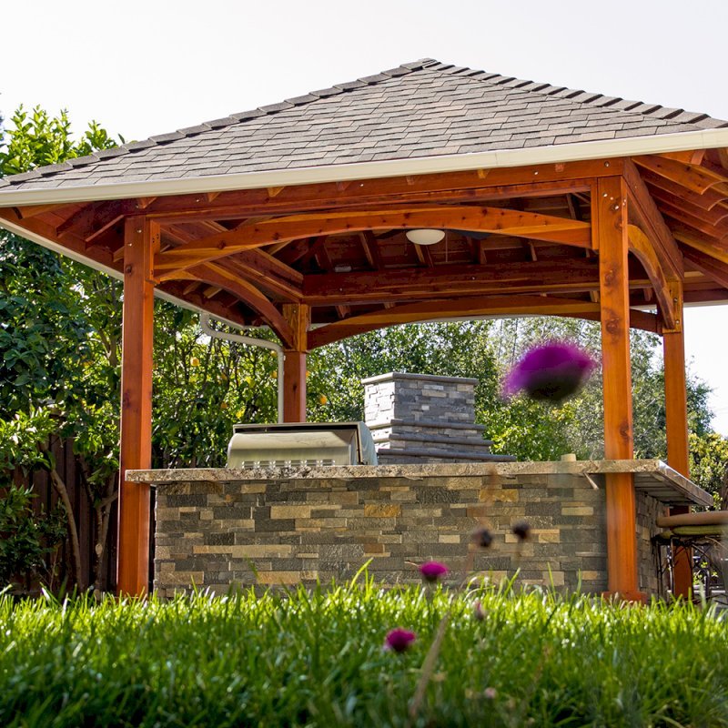 The Loreto Pavilion (Options: 14' x 14', California Redwood, Post Anchor Kit for Gale-Wind, 1 Electrical Wiring Trim Kit, 2ft Overhangs by Custom Request, Transparent Premium Sealant). Gutters added by Forever Redwood install team and can be added to any pavilion by request. Photo Courtesy of B. Hirschbeck of Los Altos, CA. The Loreto Pavilion (Options: 14' x 14', California Redwood, Post Anchor Kit for Gale-Wind, 1 Electrical Wiring Trim Kit, 2ft Overhangs by Custom Request, Transparent Premium Sealant). Gutters added by Forever Redwood install team and can be added to any pavilion by request. Photo Courtesy of B. Hirschbeck of Los Altos, CA.