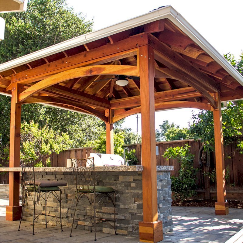 The Loreto Pavilion (Options: 14' x 14', California Redwood, Post Anchor Kit for Gale-Wind, 1 Electrical Wiring Trim Kit, 2ft Overhangs by Custom Request, Transparent Premium Sealant). Gutters added by Forever Redwood install team and can be added to any pavilion by request. Photo Courtesy of B. Hirschbeck of Los Altos, CA. The Loreto Pavilion (Options: 14' x 14', California Redwood, Post Anchor Kit for Gale-Wind, 1 Electrical Wiring Trim Kit, 2ft Overhangs by Custom Request, Transparent Premium Sealant). Gutters added by Forever Redwood install team and can be added to any pavilion by request. Photo Courtesy of B. Hirschbeck of Los Altos, CA.