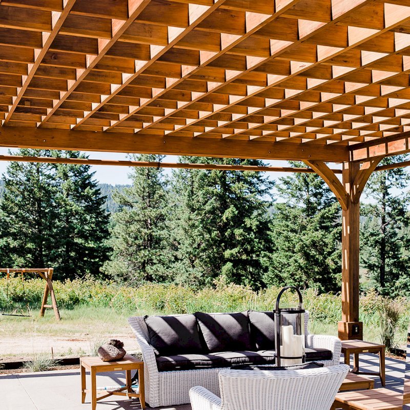The Montvale Pergola (Options: 22' x 22', Mature Redwood, Post Anchoring for Concrete, Electrical Wiring Trim Kit for 4 Posts, No Ceiling Fan Base, 4 Curtain Rods, No Privacy Panels, 10' Post, Transparent Premium Sealant). Photo Courtesy of J. Scott of Coeur deline, Idaho. The Montvale Pergola (Options: 22' x 22', Mature Redwood, Post Anchoring for Concrete, Electrical Wiring Trim Kit for 4 Posts, No Ceiling Fan Base, 4 Curtain Rods, No Privacy Panels, 10' Post, Transparent Premium Sealant). Photo Courtesy of J. Scott of Coeur deline, Idaho.