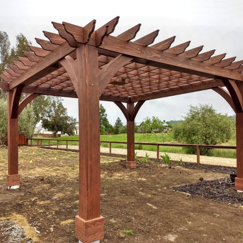 The Montvale Pergola (Options: 18' x 18', California Redwood, Post Anchoring for Gale-Wind, 1 Ceiling Fan Base, No Curtain Rods, No Privacy Panels, 10' Post, Coffee-Stain Premium Sealant). Photo Courtesy of M. Butler of Napa, CA. The Montvale Pergola (Options: 18' x 18', California Redwood, Post Anchoring for Gale-Wind, 1 Ceiling Fan Base, No Curtain Rods, No Privacy Panels, 10' Post, Coffee-Stain Premium Sealant). Photo Courtesy of M. Butler of Napa, CA.