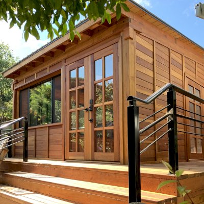 Palo Alto Backyard Cabin (Options: 18' L, 16' W, Without Porch, Structural Deck - Interior & 4' Exterior, California Redwood, Sugar Pine Internal Walls and Ceiling, Windows Purchased Locally, With Two 3' x 5' Skylights, Metal Roof, Custom Railings and Steps, Electrical Wire Trim on the Walls, Transparent Premium Sealant). Photo Courtesy of A. Ramon of South San Francisco, California.