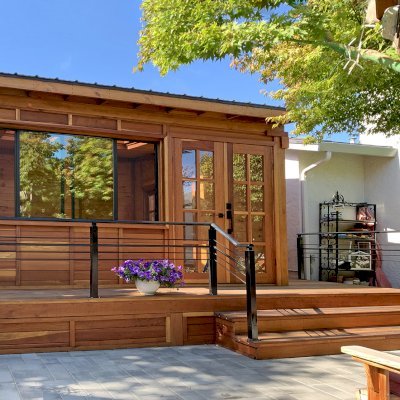 Palo Alto Backyard Cabin (Options: 18' L, 16' W, Without Porch, Structural Deck - Interior & 4' Exterior, California Redwood, Sugar Pine Internal Walls and Ceiling, Windows Purchased Locally, With Two 3' x 5' Skylights, Metal Roof, Custom Railings and Steps, Electrical Wire Trim on the Walls, Transparent Premium Sealant). Photo Courtesy of A. Ramon of South San Francisco, California.