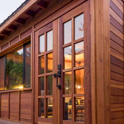 Palo Alto Backyard Cabin (Options: 18' L, 16' W, Without Porch, Structural Deck - Interior & 4' Exterior, California Redwood, Sugar Pine Internal Walls and Ceiling, Windows Purchased Locally, With Two 3' x 5' Skylights, Metal Roof, Custom Railings and Steps, Electrical Wire Trim on the Walls, Transparent Premium Sealant). Photo Courtesy of A. Ramon of South San Francisco, California.