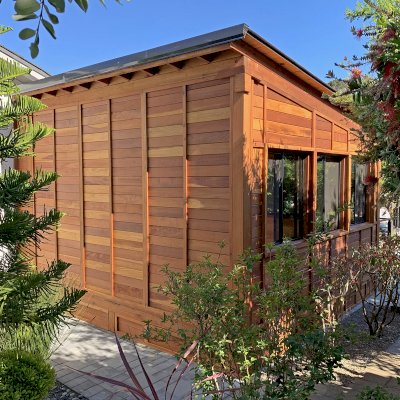 Palo Alto Backyard Cabin (Options: 18' L, 16' W, Without Porch, Structural Deck - Interior & 4' Exterior, California Redwood, Sugar Pine Internal Walls and Ceiling, Windows Purchased Locally, With Two 3' x 5' Skylights, Metal Roof, Custom Railings and Steps, Electrical Wire Trim on the Walls, Transparent Premium Sealant). Photo Courtesy of A. Ramon of South San Francisco, California.