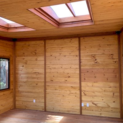 Palo Alto Backyard Cabin (Options: 18' L, 16' W, Without Porch, Structural Deck - Interior & 4' Exterior, California Redwood, Sugar Pine Internal Walls and Ceiling, Windows Purchased Locally, With Two 3' x 5' Skylights, Metal Roof, Custom Railings and Steps, Electrical Wire Trim on the Walls, Transparent Premium Sealant). Photo Courtesy of A. Ramon of South San Francisco, California.