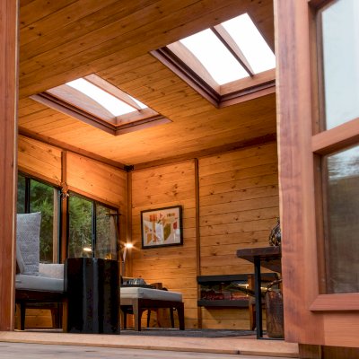 Palo Alto Backyard Cabin (Options: 18' L, 16' W, Without Porch, Structural Deck - Interior & 4' Exterior, California Redwood, Sugar Pine Internal Walls and Ceiling, Windows Purchased Locally, With Two 3' x 5' Skylights, Metal Roof, Custom Railings and Steps, Electrical Wire Trim on the Walls, Transparent Premium Sealant). Photo Courtesy of A. Ramon of South San Francisco, California.