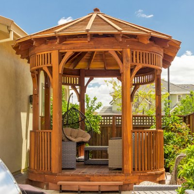 The Palomar Round Pavilion (CUSTOM OPTIONS: 15' L x 10'-6" W, Oval Shape Instead of Hexagonal by Custom Request, with Deck, California Redwood, With Upper Corvels and Lower Panels, Transparent Premium Sealant). Photo Courtesy of A. Singh of Dublin, California.