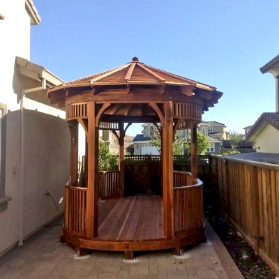The Palomar Round Pavilion (CUSTOM OPTIONS: 15' L x 10'-6" W, Oval Shape Instead of Hexagonal by Custom Request, with Deck, California Redwood, With Upper Corvels and Lower Panels, Transparent Premium Sealant). Photo Courtesy of A. Singh of Dublin, California.