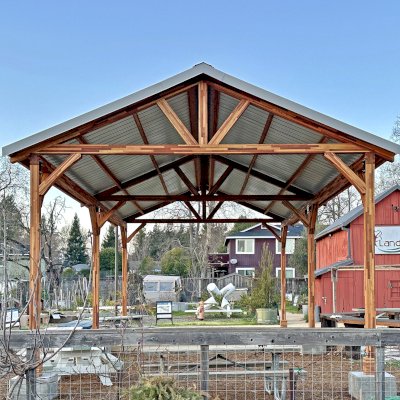 The San Carlos Carport Pavilion (Options: 40' L x 20' W, Mosaic Redwood, 6- Post Stainless Steel High Wind Anchor Kit, 10' H Posts, 6x6 Posts, Electrical Wiring Trim Kit for 1 Post, Transparent Premium Sealant). Order installed at Bayer Park Gardens, 1550 West Ave. Santa Rosa, CA.