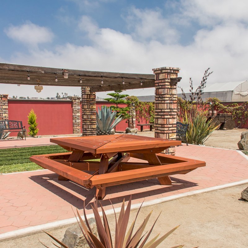 The Sea Ranch Picnic Table (options: 6ft x 6ft tabletop size, California Redwood, Slightly Rounded Corners (1/2-in radius), Transparent Premium Sealant). The Sea Ranch Picnic Table (options: 6ft x 6ft tabletop size, California Redwood, Slightly Rounded Corners (1/2-in radius), Transparent Premium Sealant).