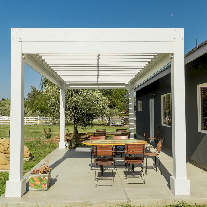The Silverado Modern Pergola (Options: 20' L, 10' W, 12" Roof Rafter Spacing, Mosaic Eco-Wood, 4-Post Anchor kit for Concrete, White Primer). The Silverado Modern Pergola (Options: 20' L, 10' W, 12" Roof Rafter Spacing, Mosaic Eco-Wood, 4-Post Anchor kit for Concrete, White Primer).
