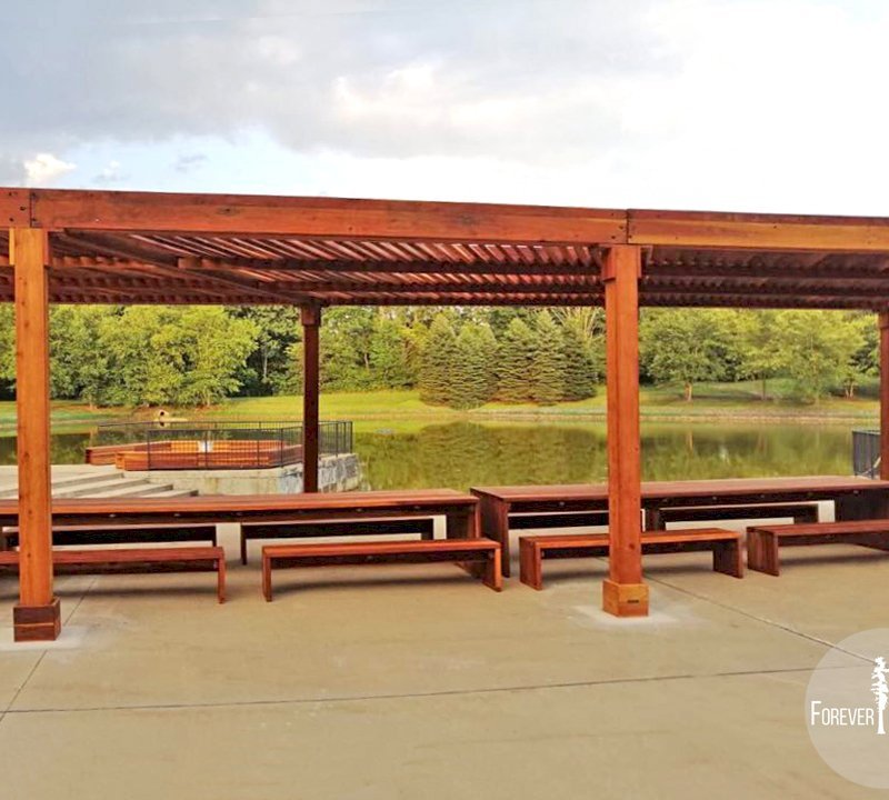 The Silverado Modern Pergola (options: 58' L, 16' W, Redwood, No Electrical Wiring Trim, with 1 3/4" x 11 1/4" Roof Support Timbers and 7 1/4" x 7 1/4" Posts, 8 Post Anchor Kit for Concrete, No Privacy Panels, No Curtain Rods, 10' Post Height, Transparent Premium Sealant). Photo Also Shows 2 Maynard Modern Redwood Patio Table Sets Under the Pergola. Photo Courtesy of A. Arena of Morristown, New Jersey. The Silverado Modern Pergola (options: 58' L, 16' W, Redwood, No Electrical Wiring Trim, with 1 3/4" x 11 1/4" Roof Support Timbers and 7 1/4" x 7 1/4" Posts, 8 Post Anchor Kit for Concrete, No Privacy Panels, No Curtain Rods, 10' Post Height, Transparent Premium Sealant). Photo Also Shows 2 Maynard Modern Redwood Patio Table Sets Under the Pergola. Photo Courtesy of A. Arena of Morristown, New Jersey.