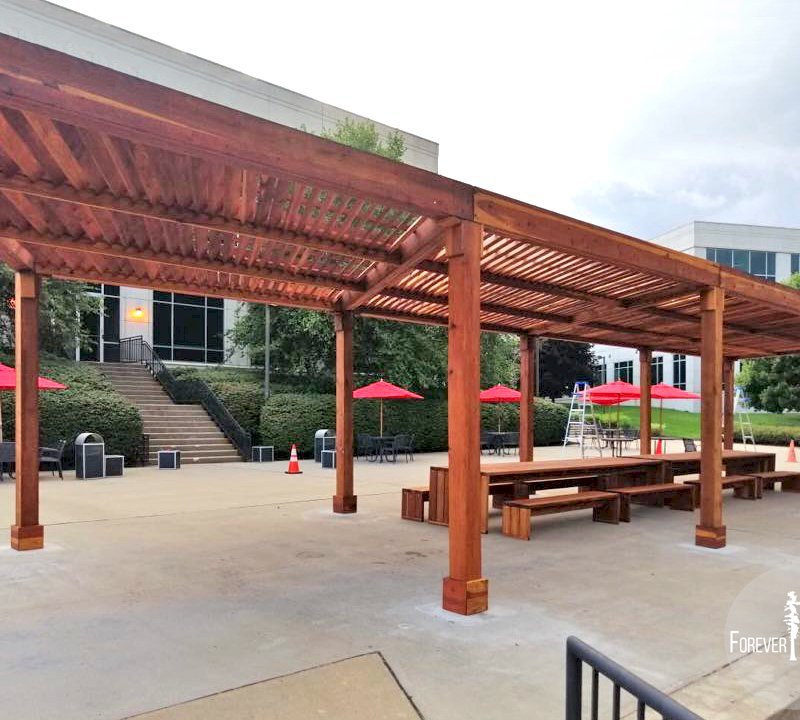 The Silverado Modern Pergola (options: 58' L, 16' W, Redwood, No Electrical Wiring Trim, with 1 3/4" x 11 1/4" Roof Support Timbers and 7 1/4" x 7 1/4" Posts, 8 Post Anchor Kit for Concrete, No Privacy Panels, No Curtain Rods, 10' Post Height, Transparent Premium Sealant). Photo Also Shows 2 Maynard Modern Redwood Patio Table Sets Under the Pergola. Photo Courtesy of A. Arena of Morristown, New Jersey. The Silverado Modern Pergola (options: 58' L, 16' W, Redwood, No Electrical Wiring Trim, with 1 3/4" x 11 1/4" Roof Support Timbers and 7 1/4" x 7 1/4" Posts, 8 Post Anchor Kit for Concrete, No Privacy Panels, No Curtain Rods, 10' Post Height, Transparent Premium Sealant). Photo Also Shows 2 Maynard Modern Redwood Patio Table Sets Under the Pergola. Photo Courtesy of A. Arena of Morristown, New Jersey.
