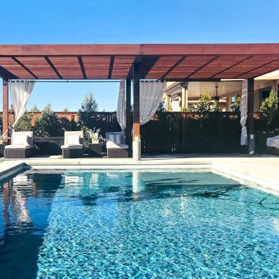 The Silverado Modern Pergola (Options: 30'-8" L, 16' W, Cantilevered Roof Style, California Redwood, No Electrical Wiring Trim, with 1 3/4" x 11 1/4" Roof Support Timbers and 7 1/4" x 7 1/4" Posts, Roof Rafter Spacing at 6", 6 Post Anchor Kit for High-Wind, No Privacy Panels, No Curtain Rods, 10' Post Height, Coffee-Stain Premium Sealant). Photo Courtesy of B. Aronson of Lincoln, CA.