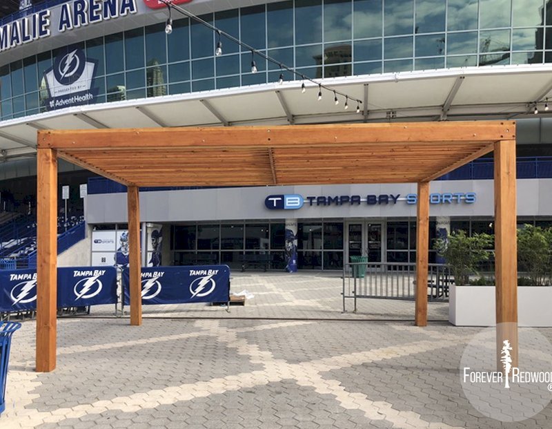The Silverado Modern Pergola (options: 20' L, 20' W, Douglas-fir, No Electrical Wiring Trim, 7 1/4" x 7 1/4" Posts, No Privacy Panels, No Curtain Rods, 9.5' Post Height, Transparent Premium Sealant). Photo Courtesy of The Tampa Bay Lightning NHL Team. The Silverado Modern Pergola (options: 20' L, 20' W, Douglas-fir, No Electrical Wiring Trim, 7 1/4" x 7 1/4" Posts, No Privacy Panels, No Curtain Rods, 9.5' Post Height, Transparent Premium Sealant). Photo Courtesy of The Tampa Bay Lightning NHL Team.